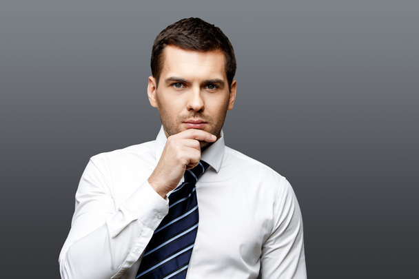 Handsome stylish businessman on grey background - Fotó, kép