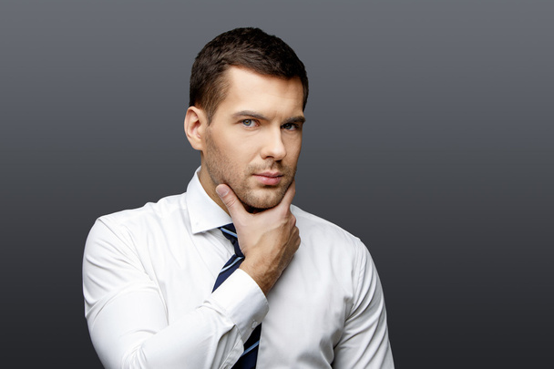 Handsome stylish businessman on grey background - Fotografie, Obrázek