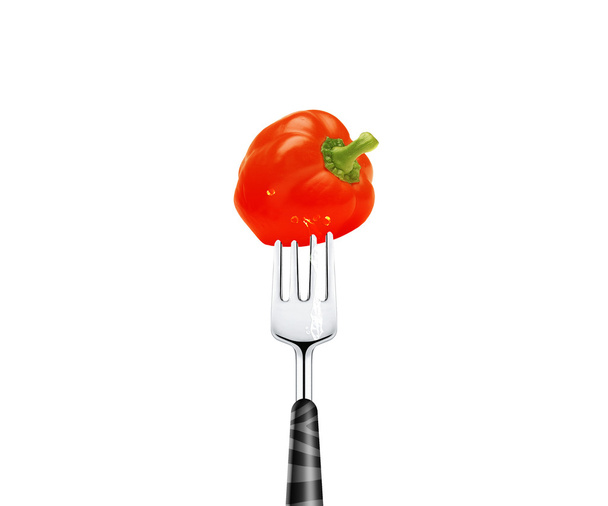 Red pepper pierced by fork, isolated on white background - Fotó, kép