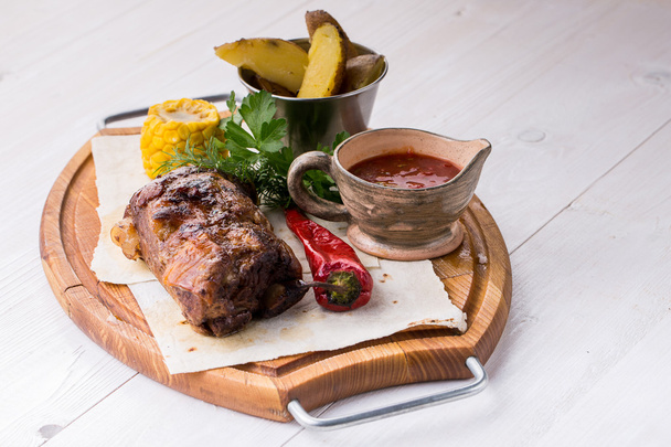 Assorted delicious grilled meat with vegetable over wooden plate - Fotó, kép