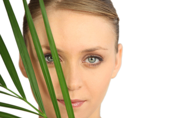 Woman hiding behind a fern - Foto, imagen