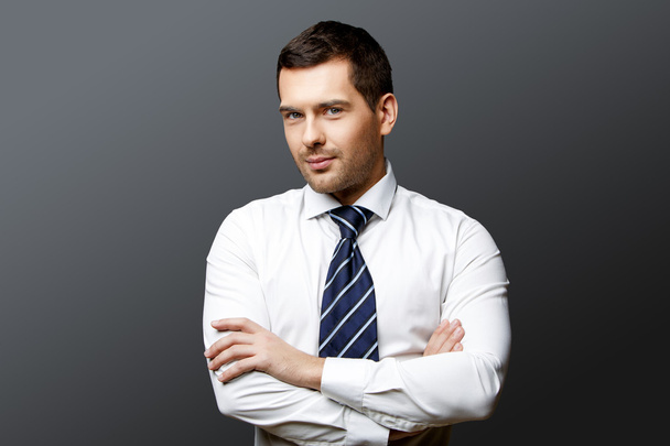 Handsome stylish businessman on grey background - Photo, image