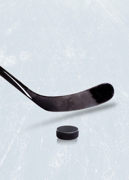 Ice hockey stick and puck on ice with copy space.  - Photo, Image