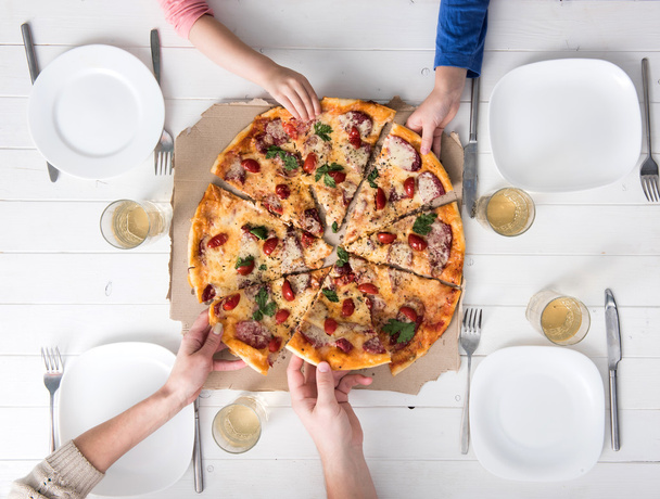 four hands taking pieces of pizza - Zdjęcie, obraz