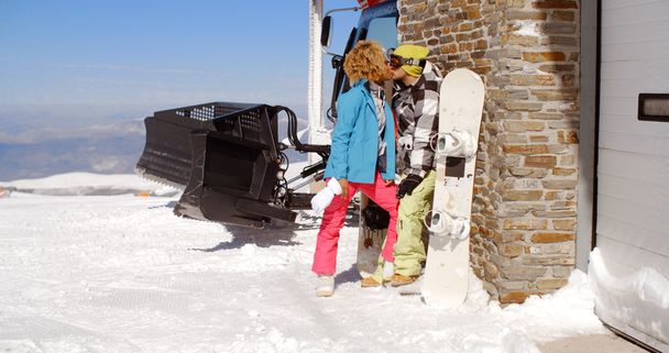 couple kissing behind ski resort - Photo, Image