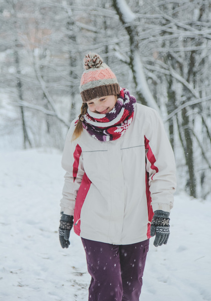 The girl walks in winter park and smiling - Фото, изображение