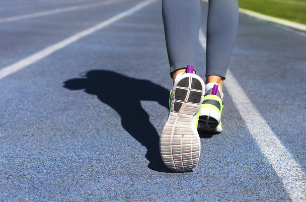 Athlete runner feet down stadium track. Jogging, sport, healthy  - Foto, immagini