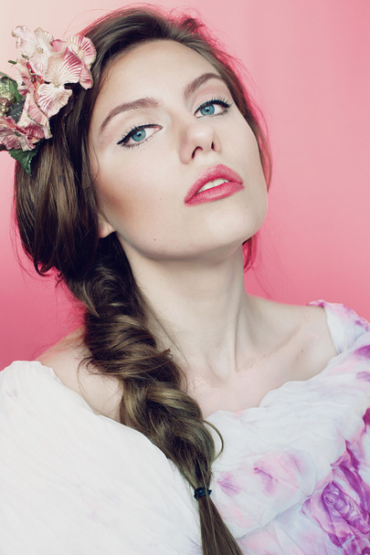 Beautiful young woman with delicate flowers in their hair - Photo, Image