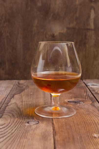 Brandy Glass on a wooden background - Fotoğraf, Görsel