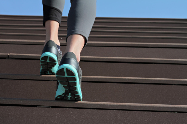Female athlete running on stairs close up. Running, jogging, sport, fitness, active lifestyle concept - Fotó, kép