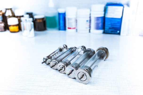 Syringe with glass vials and medications pills - Фото, изображение