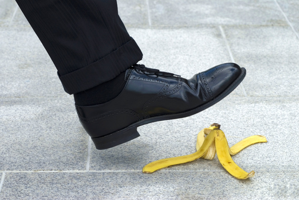 Businessman stepping on banana skin - Photo, Image