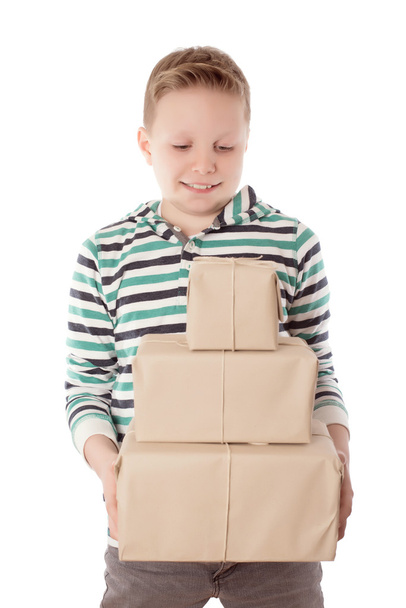 Happy young boy holding a gift box over the white - Foto, Imagen