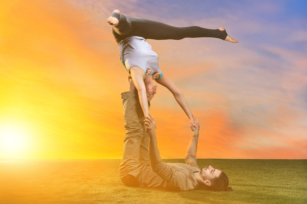 The two people doing yoga exercises - 写真・画像