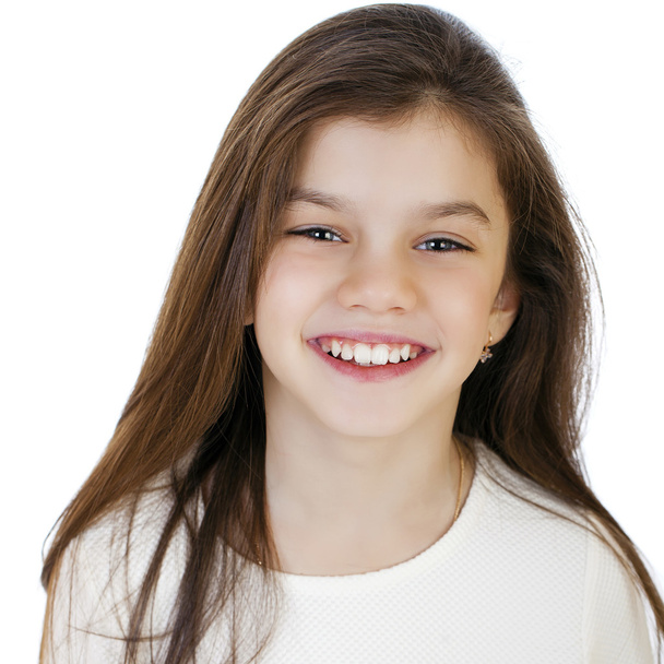 Portrait of a charming little girl smiling at camera - Фото, изображение
