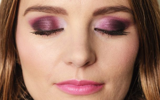 Woman closed eyes with violet dark shadows makeup  - Valokuva, kuva