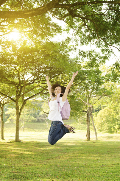 Young Asian college girl student open arms jumping - Photo, image