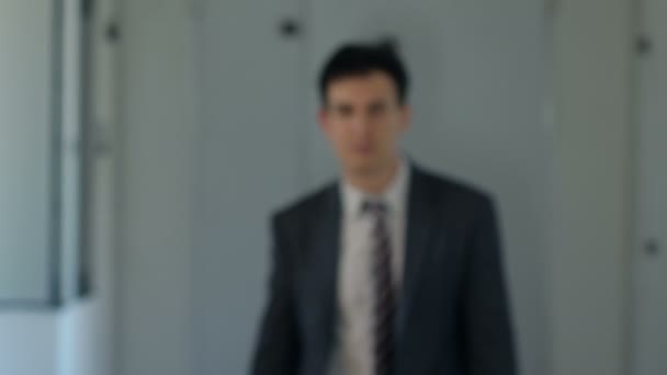 confident and beautiful businessman walking toward the camera - Materiał filmowy, wideo