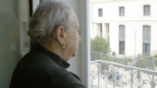 old depressed woman looking out the window - Video, Çekim