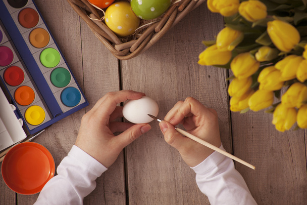 close up of woman hands coloring easter eggs - Fotó, kép
