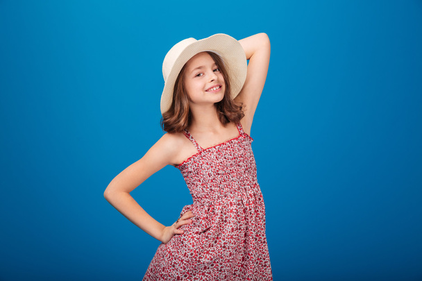 Portrait of beautiful smiling little girl in hat and sundress   - Valokuva, kuva