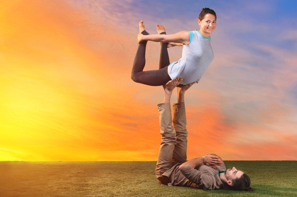 The two people doing yoga exercises - Zdjęcie, obraz