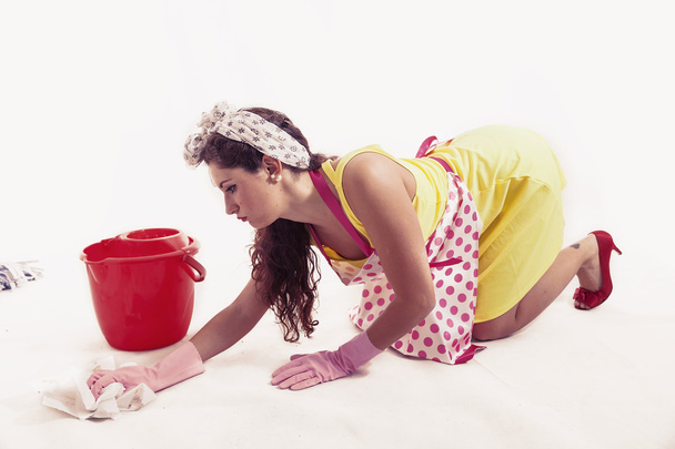 pretty housemaid with cloth and bucket cleaning the floor - Foto, immagini