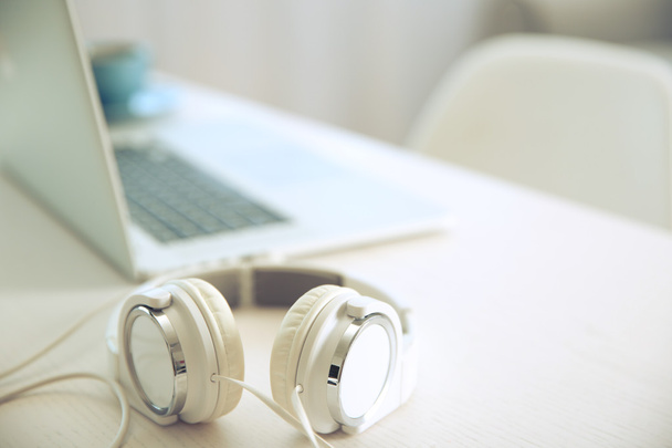 Headphones and laptop on table  - Foto, Bild
