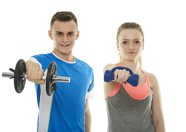 Teenagers working out with dumbbells - Foto, Bild