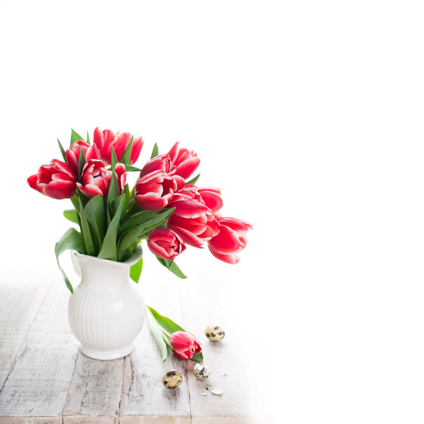 Bouquet of pink tulips in vase on the white background - 写真・画像