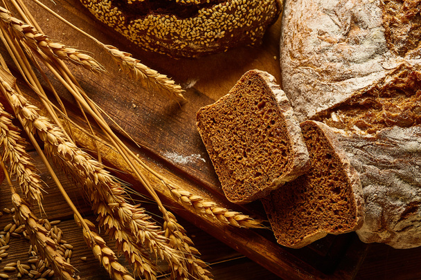 Fresh bread and wheat ears - Fotó, kép
