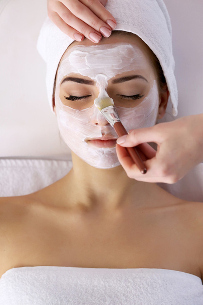 Young woman with facial mask - 写真・画像