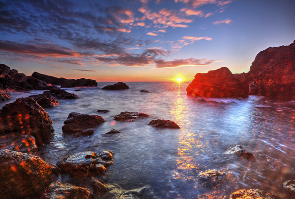 Схід сонця на скелястий берег і драматичні небі хмари - Фото, зображення