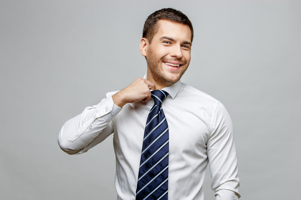 Handsome stylish businessman on grey background - Foto, immagini