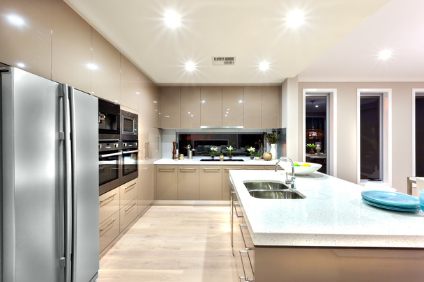 Modern kitchen with refrigerator and fixed to the wall with cabi - 写真・画像
