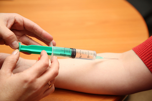 an injection syringe in hand - Photo, Image