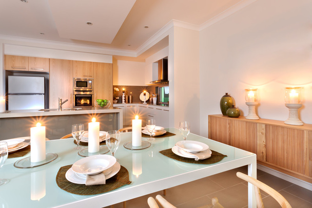 Closeup of a dining table set up in front of the kitchen with fl - Photo, image