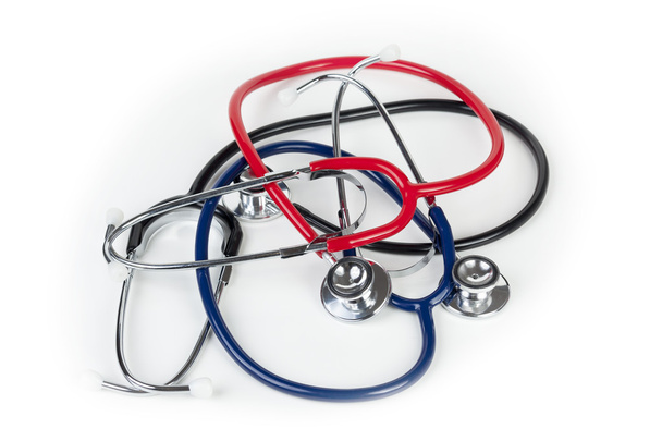 Red blue and black stethoscopes laying on medical worktop - Photo, Image