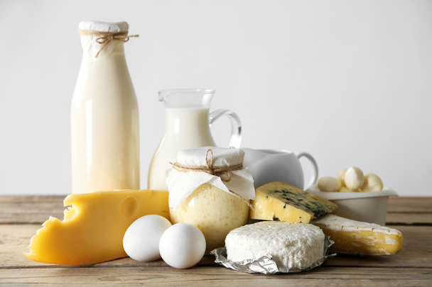 Set of fresh dairy products on wooden table, on white background - Фото, зображення