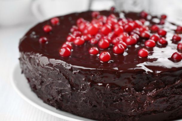 Chocolate cake with cranberries on plate, closeup - Fotó, kép