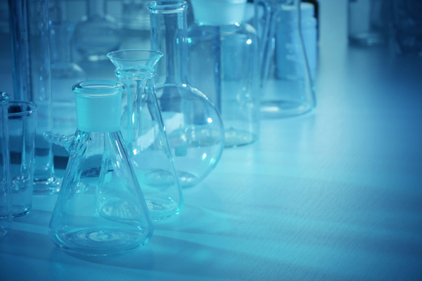 Laboratory glassware on table - Zdjęcie, obraz