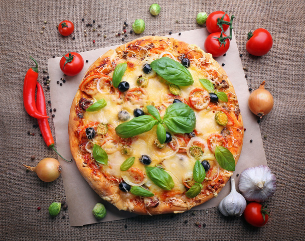 Delicious fresh pizza on sackcloth, top view - Фото, зображення