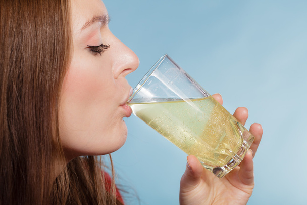 Woman drink pill dissolved in water. Health care. - Valokuva, kuva