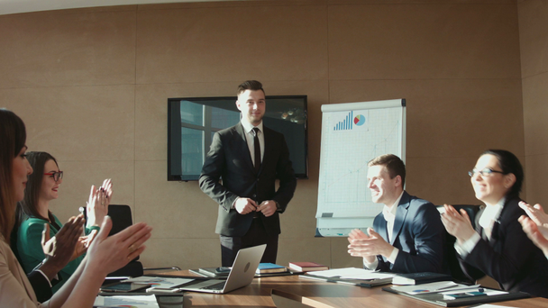 Colleagues applauding businessman in office - Felvétel, videó