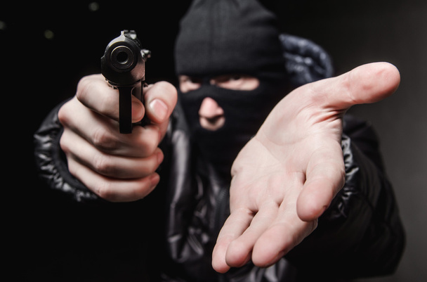 Robber with an aming gun - Foto, Bild