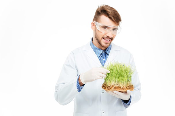 Male engineer showing modified plants - Foto, Imagem