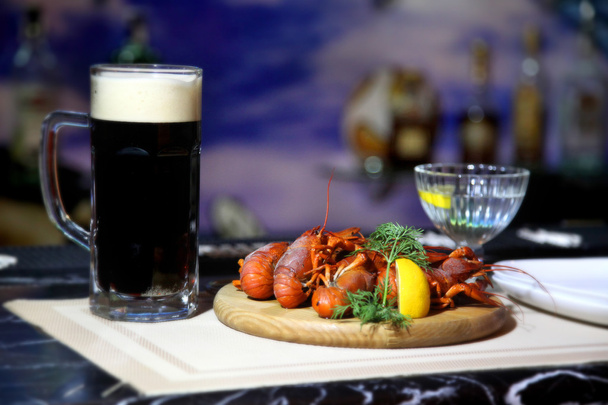 Crayfish party. Boiled crawfish with beer on a wooden plate. Tasty boiled crayfishes and beer on old table - Stock Image - Photo, Image