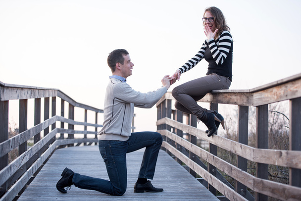 Man in love making propose to a surprised girlfriend, engagement - Foto, Imagen