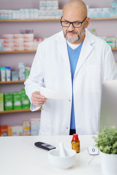 Pharmacist checking a prescription - Valokuva, kuva