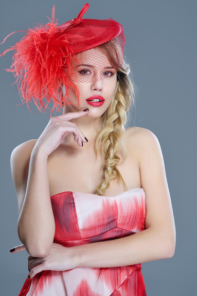Woman fashion portrait in red vintage hat with feathers - Photo, Image